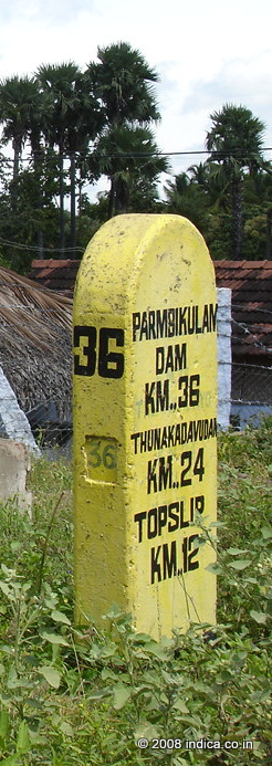 Milestone at the entry point of Indira Gandhi-National Park showing distances to Parambikulam and Top Slip