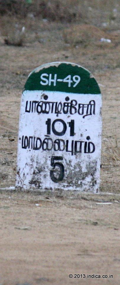 A milestone in Tamil language on the ECR showing distances to Pondicherry (101 km) and Mahabalipuram (5km)