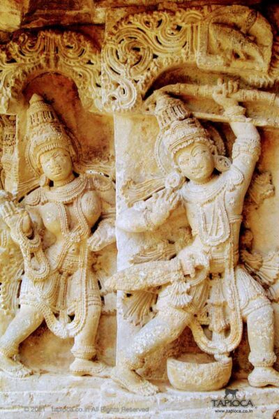 Arjuna aiming at fish at the mast looking at the shadow in the pool beneath (note the trough). A mythical theme from Mahabarata varved on the wall of Mallikarjuna Temple, Basaralu in Mandya