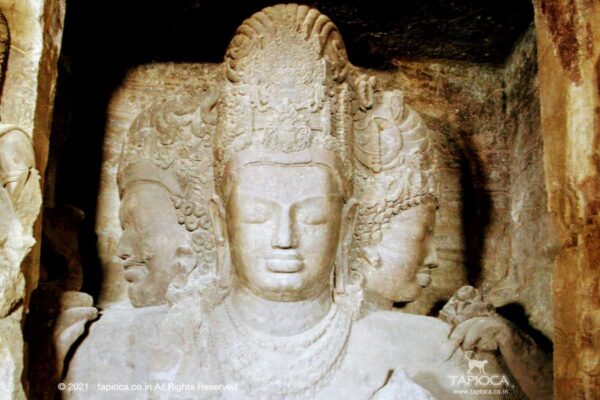 The center piece, the star attraction of Elephanta cave temple iconic image of the three headed Shiva called Mahesh , the great Lord.