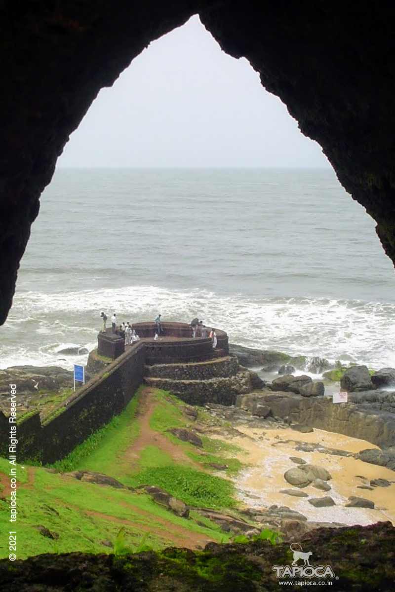 The extended circular bastion and its connecting wall to the fort seen through an arch window on the fort wall.