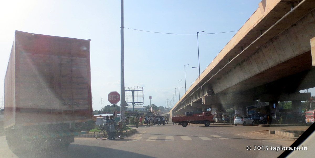 NH 275 crosses Tumkur Road (NH48) near Nelamangala. Take the left diversion under the flyover to driver towards Mangalore. 