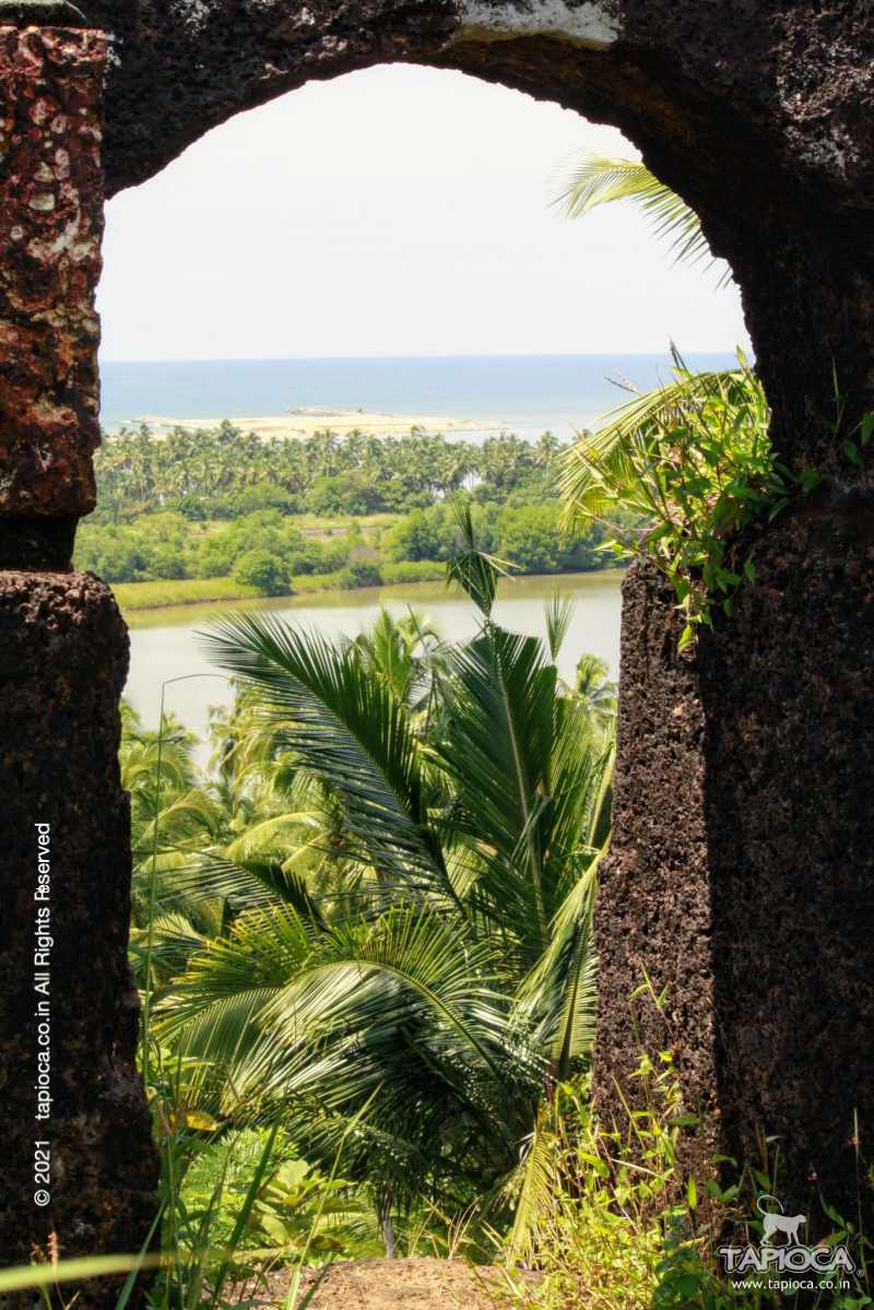 Window carved out of the natural laterite hill. Seen through the window is the Arabian Sea.